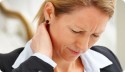 Professional Woman looking stressed and holding her neck