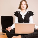 Woman meditating on her desk