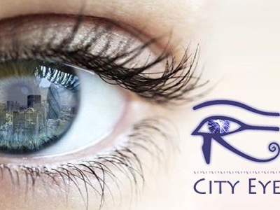 The City Eye Blog Logo - A picture of a woman's eye and the reflection of the London skyline reflected in her eye.