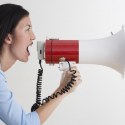 Woman shouting into megaphone Feature