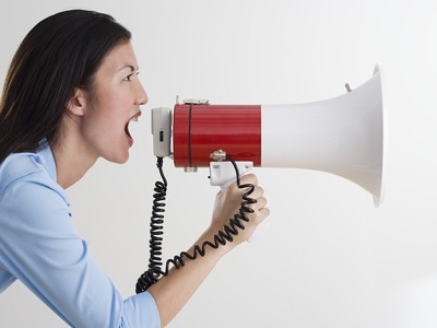 Woman shouting into megaphone Feature