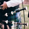 man playing bagpipes in kilt burn's night featured