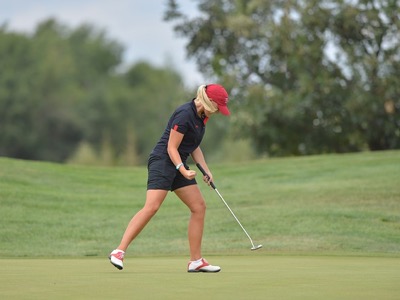 female golfer playing at golf club featured