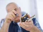 male electrician working on a plug featured