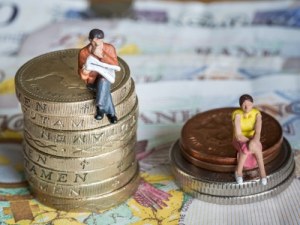 man-and-woman-sat-on-money-piles-gender-pay-gap-featured