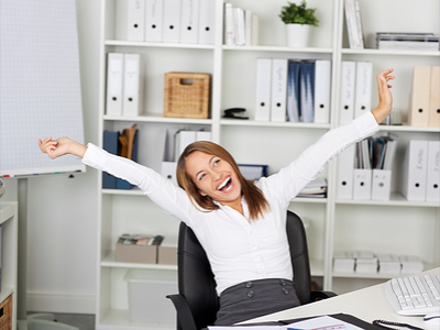 Female Entrepreneur in her office and smiling with arms outstretched