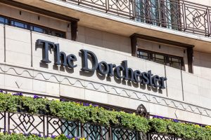 The Dorchester Hotel advertising logo sign outside its hotel in Park Lane Mayfair Hyde Park which is a popular travel destination tourist landmark of the city centre