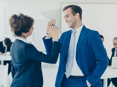colleagues giving an office high-five featured