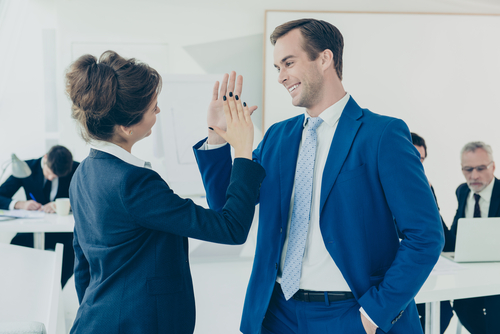 colleagues giving an office high-five