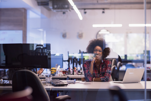 black business woman sitting at her desk