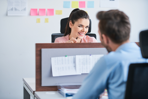 couple flirt in the office