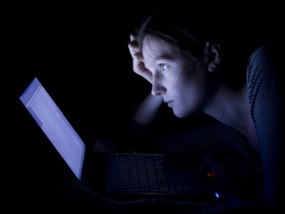 woman on computer in the dark, revenge porn featured