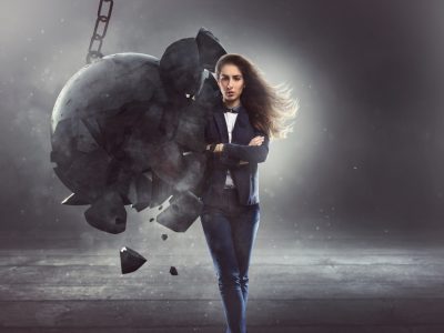 resilient business woman, woman being hit by wrecking bacll
