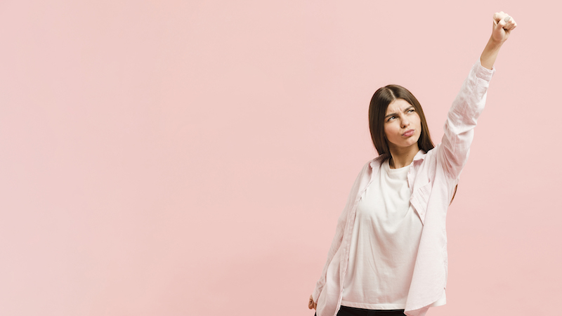 woman being resilient on pink background