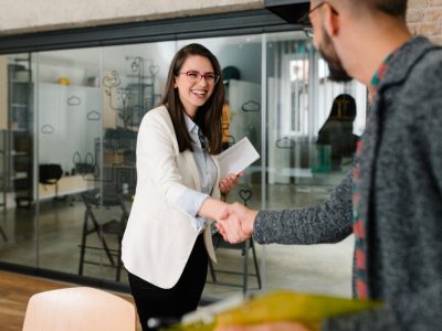 Openly greeting a job recruiter with a firm handshake, recruitment industry, new role