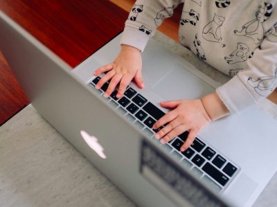 baby typing on a laptop, single parent business owner, entrepreneur