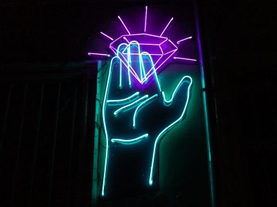 neon sign, hand holding a diamond