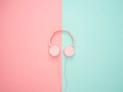 pink headphones on background, wearing headphones at work