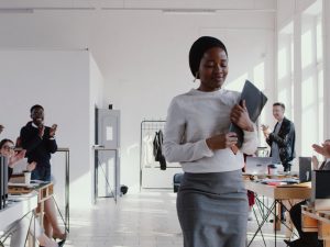 shy, introverted woman being clapped in the office
