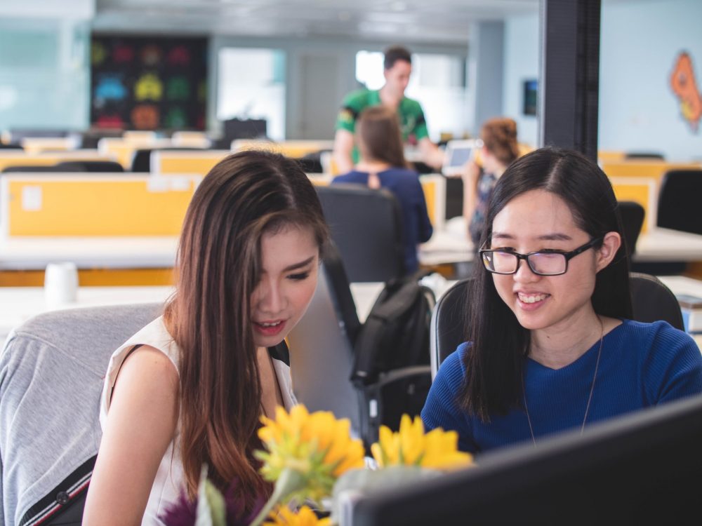 Two Asian women working together in an office, working women