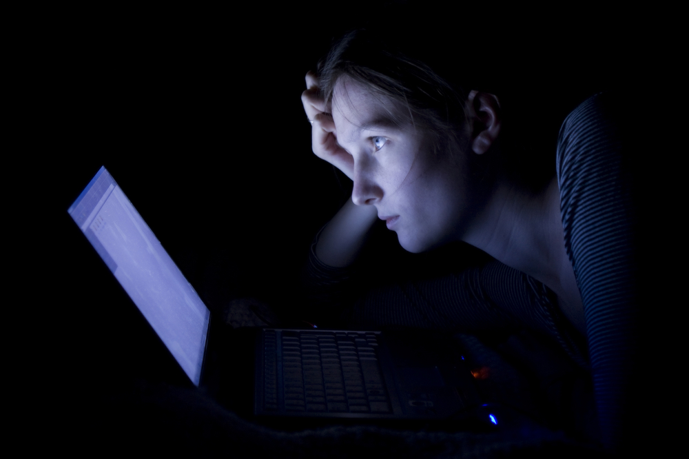 Young woman with laptop at night