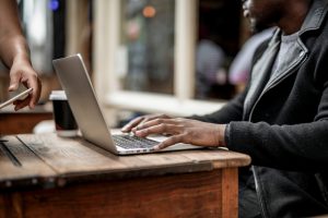 Businessman working remotely from a cafe, flexible working