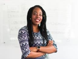 smiling black business woman with her arms crossed, Louise Findlay-Wilson