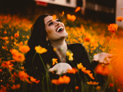 woman smiling in a field of flowers, growth, grow