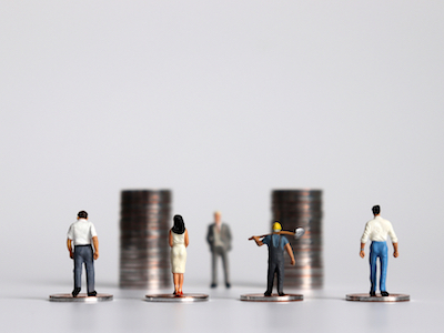 Miniature people with piles of coins, minimum wage, pay gap, pay transparency, equal pay