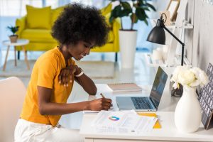 side view of smiling african american female freelancer working at home.jpg
