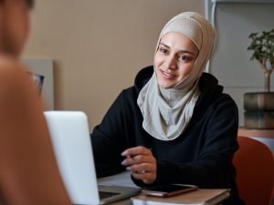 Happy woman wearing hijab smiling during job interview