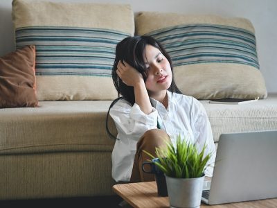 young woman suffering from overwhelm while working from home
