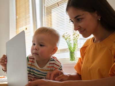 Working mother working from home with young baby