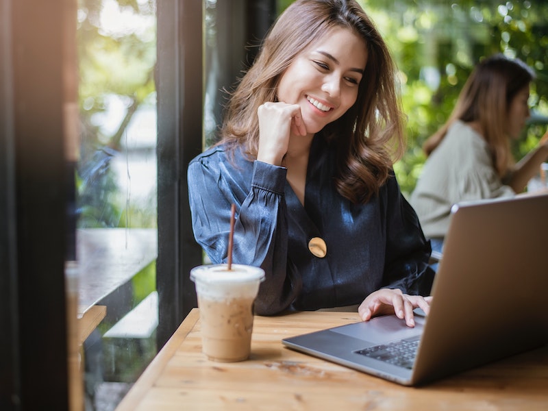 happy smiling woman working remotely, wellbeing