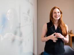 Happy professional woman presenting at work