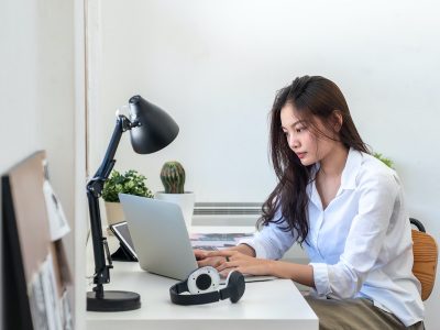 Young woman sitting at desk working