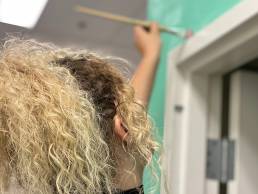 woman painting a wall
