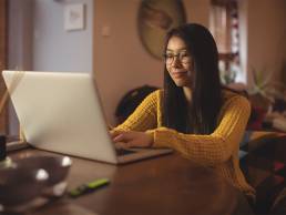 woman using laptop table living room