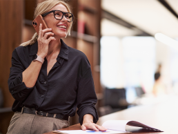 Smiling business woman receiving a job opportunity on LinkedIn