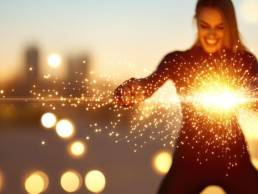 woman conjuring energy shining