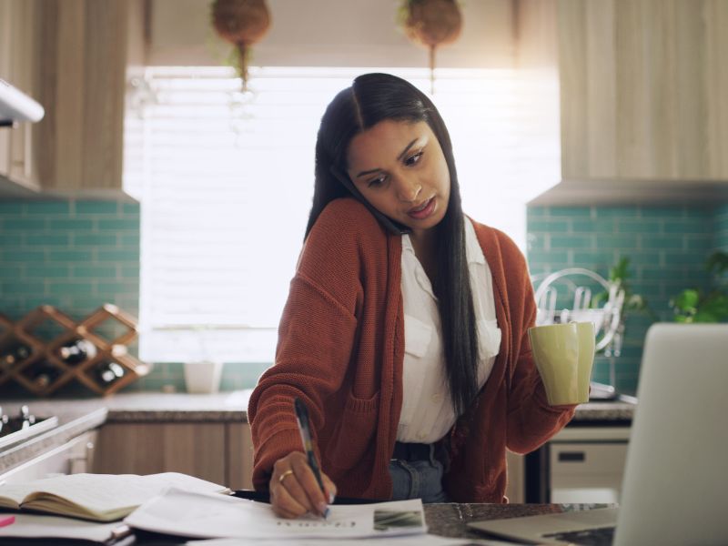 Remote work phone call and woman with laptop and paperwork for project