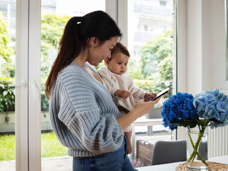 Medium shot woman holding baby